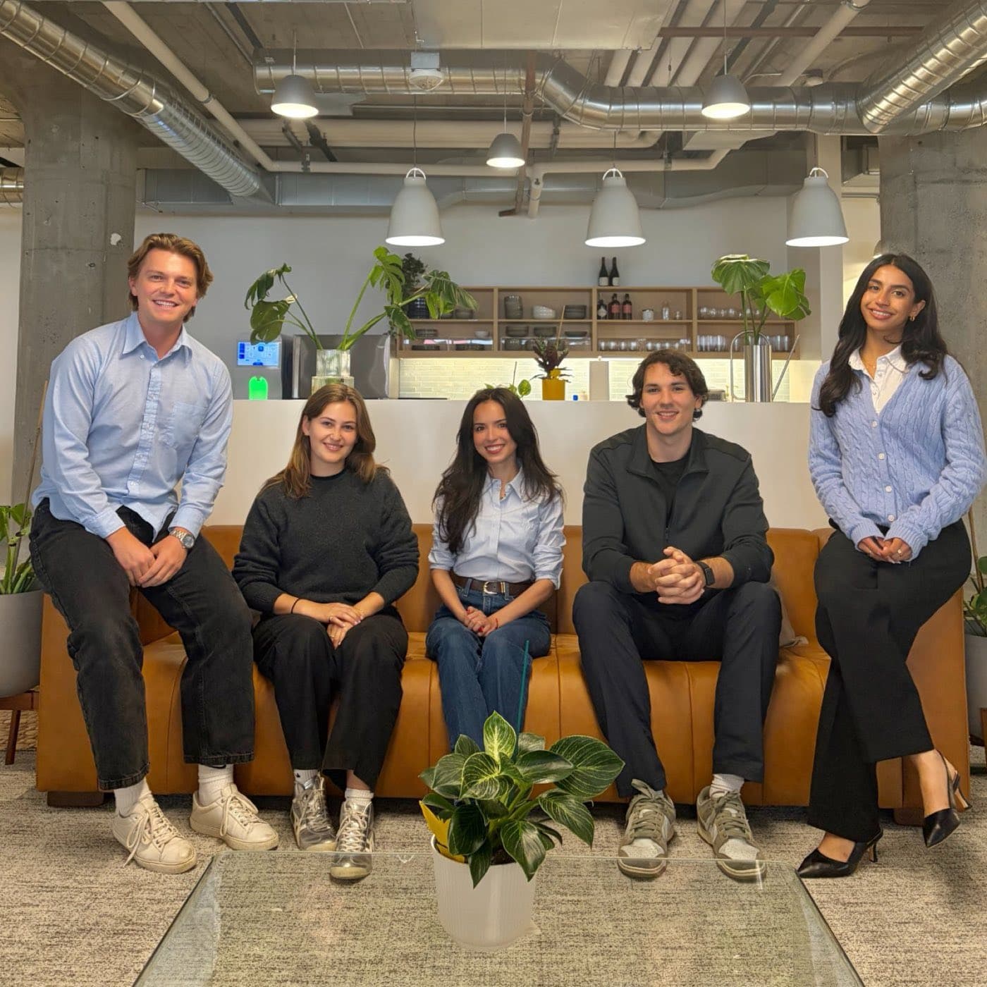 Five teammates gathered on the couch in the San Francisco office